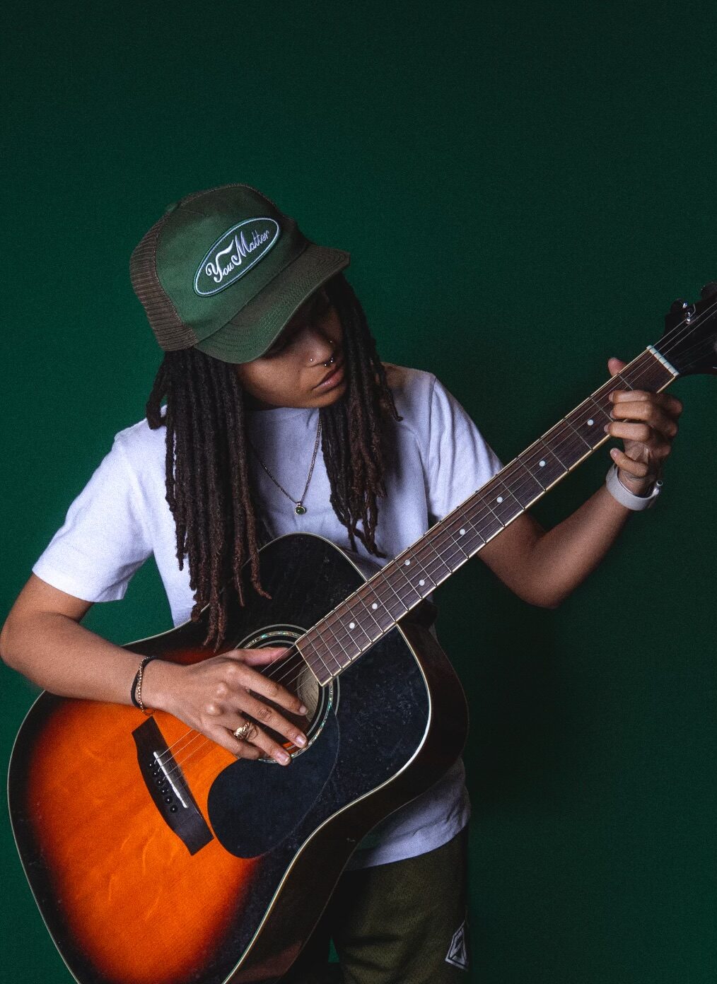 First Law Studio portrait holding a guitar