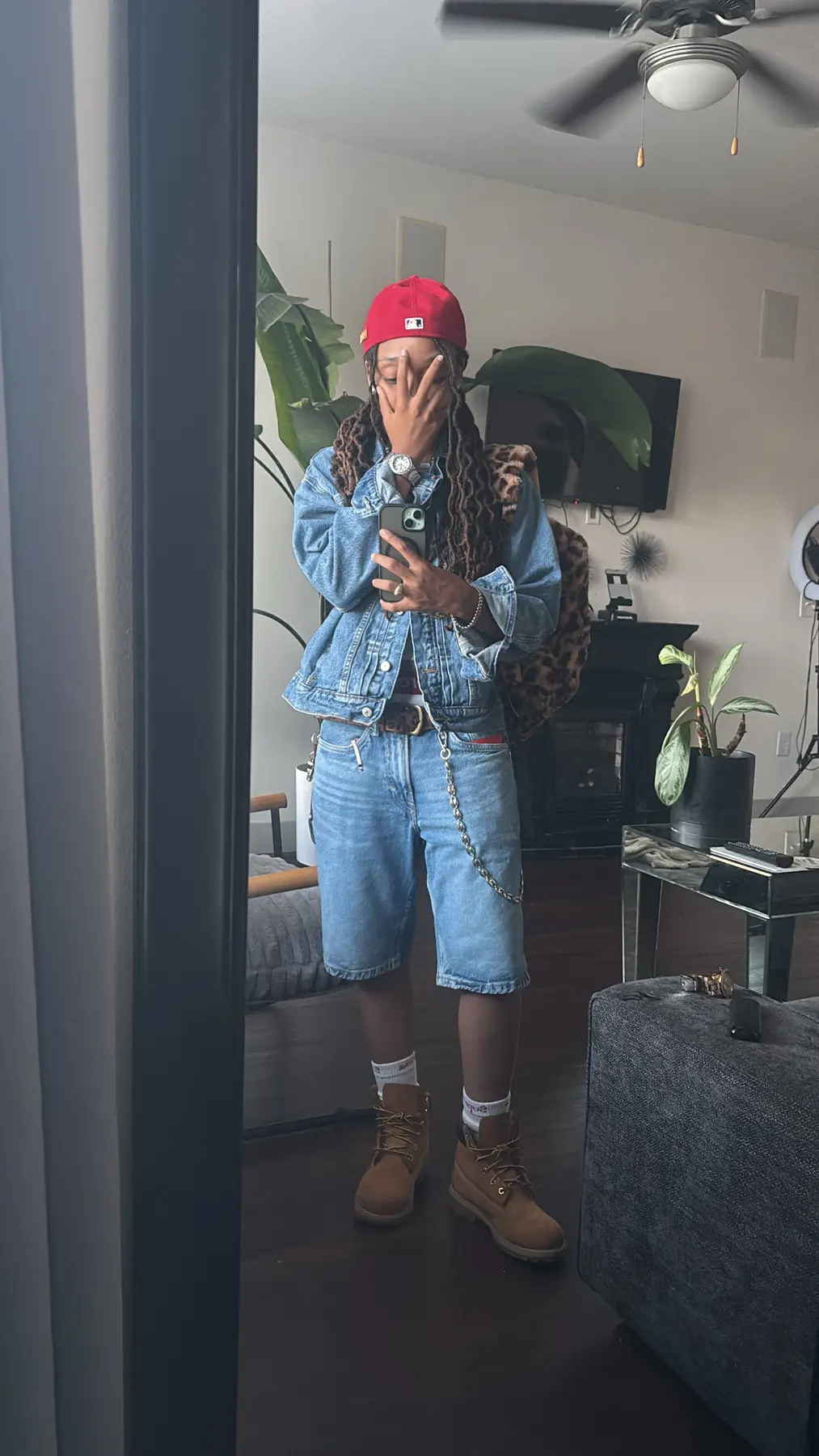 Denim streetwear look with a red cap