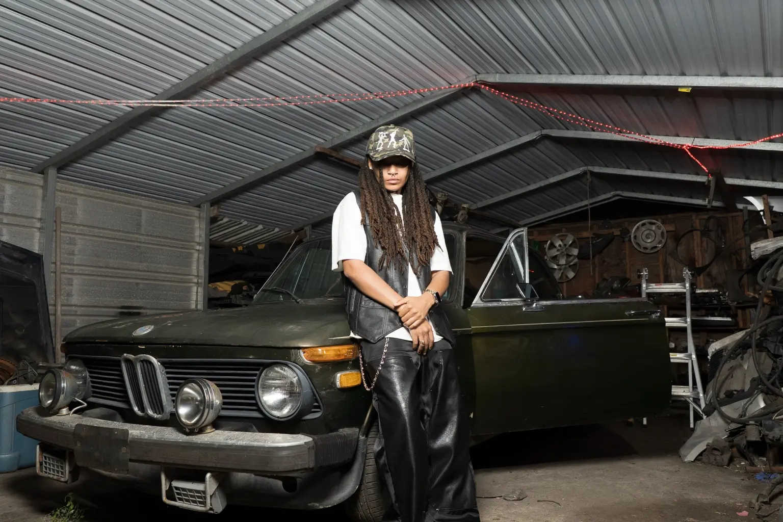 Editorial portrait beside a vintage car
